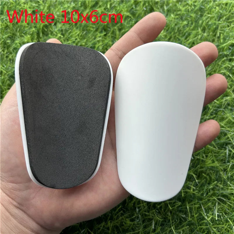 Extra small mini football shin guards in black and white colours measuring 8x5cm