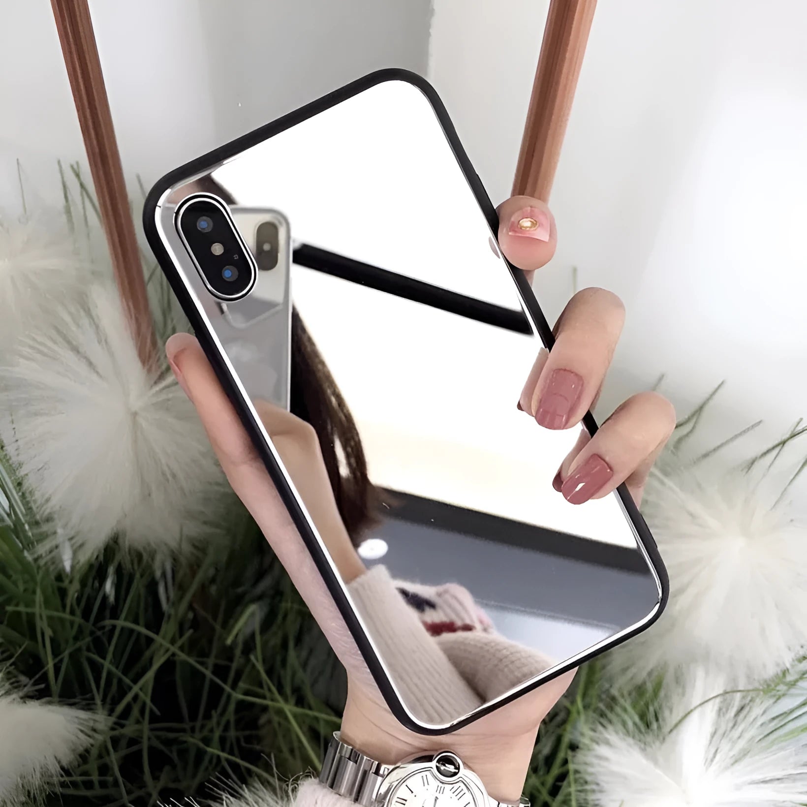 Black iPhone mirror phone case showing reflective glass back, compatible with multiple iPhone models.