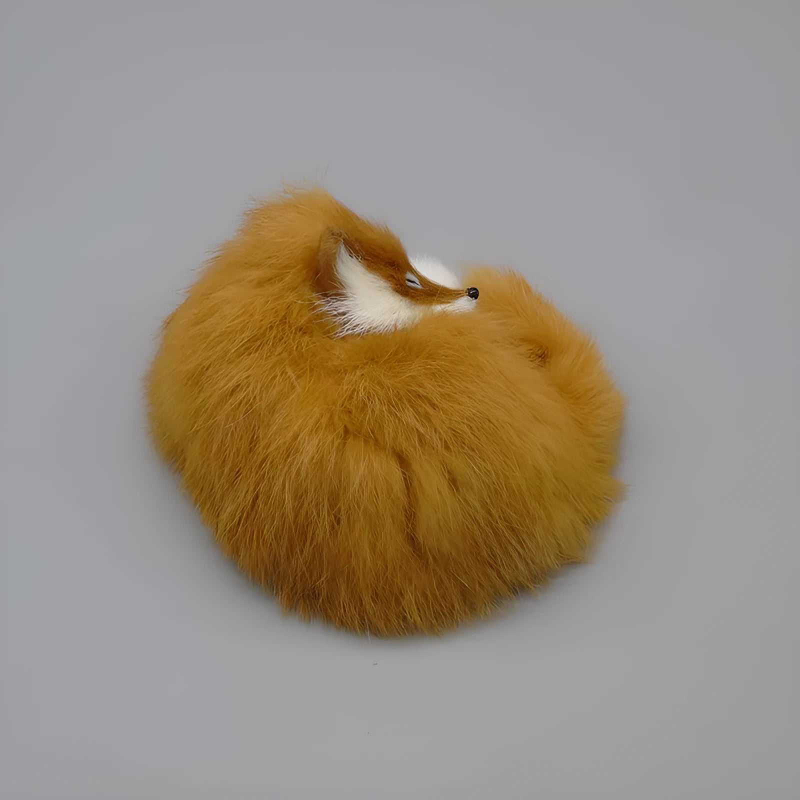 Artificial white fox fur car decoration handicraft on a dashboard.