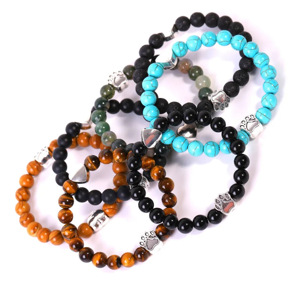A round beaded stone bracelet in a Tiger Eye or Indian Agate style on a wrist.
