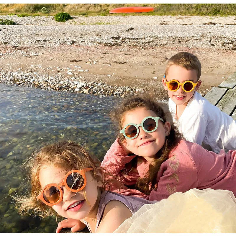 Children round frame retro mocha glasses on a child, showing the PC frame and resin lenses available in Beige, Brown, Green, Orange Red, Orange Yellow, Pink, and Purple colours