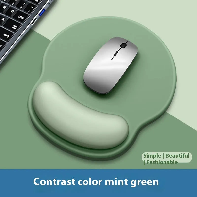 Silicone mouse mat with attached gel wrist support in a gradient blue colour on a desk.