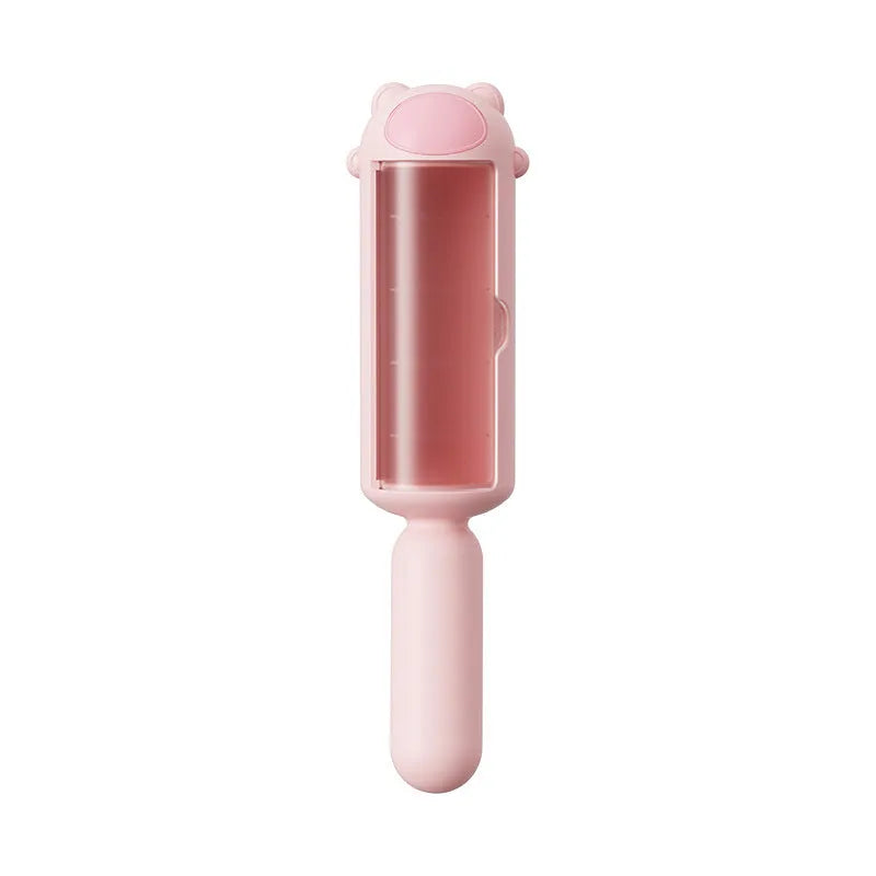 Blue reusable pet hair remover roller with a self-cleaning base on a fabric sofa.