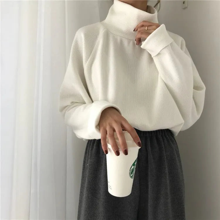 Women's solid colour long sleeve top with a half-high collar in a loose fit, shown in apricot.
