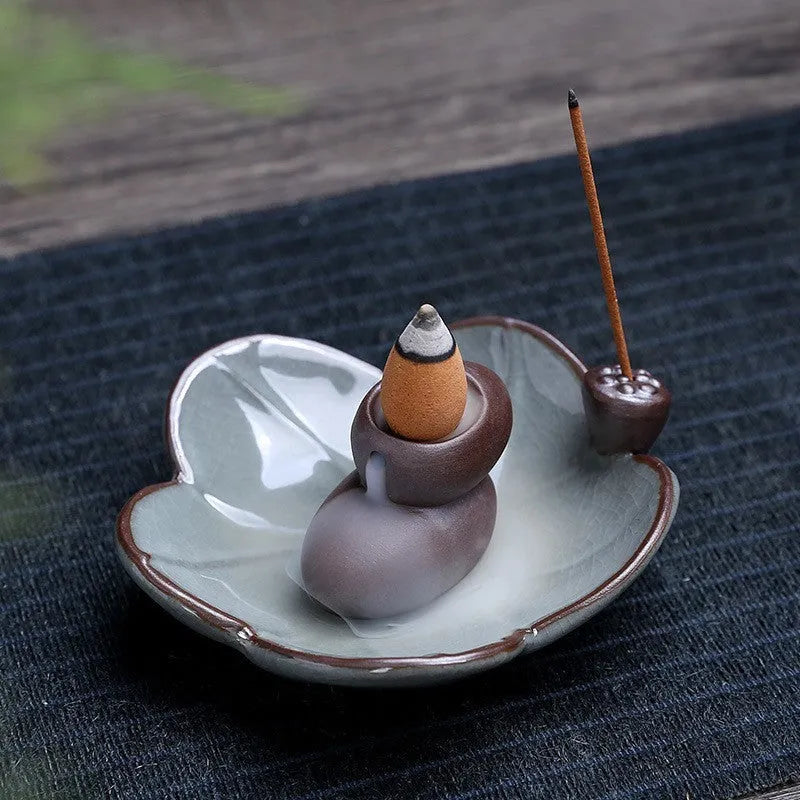 Ceramic reverse flow incense burner in purple clay with crystal glaze featuring lotus or plum blossom design