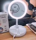 White acrylic frame vanity mirror with LED lights, USB charging port, and foldable design showing storage compartments
