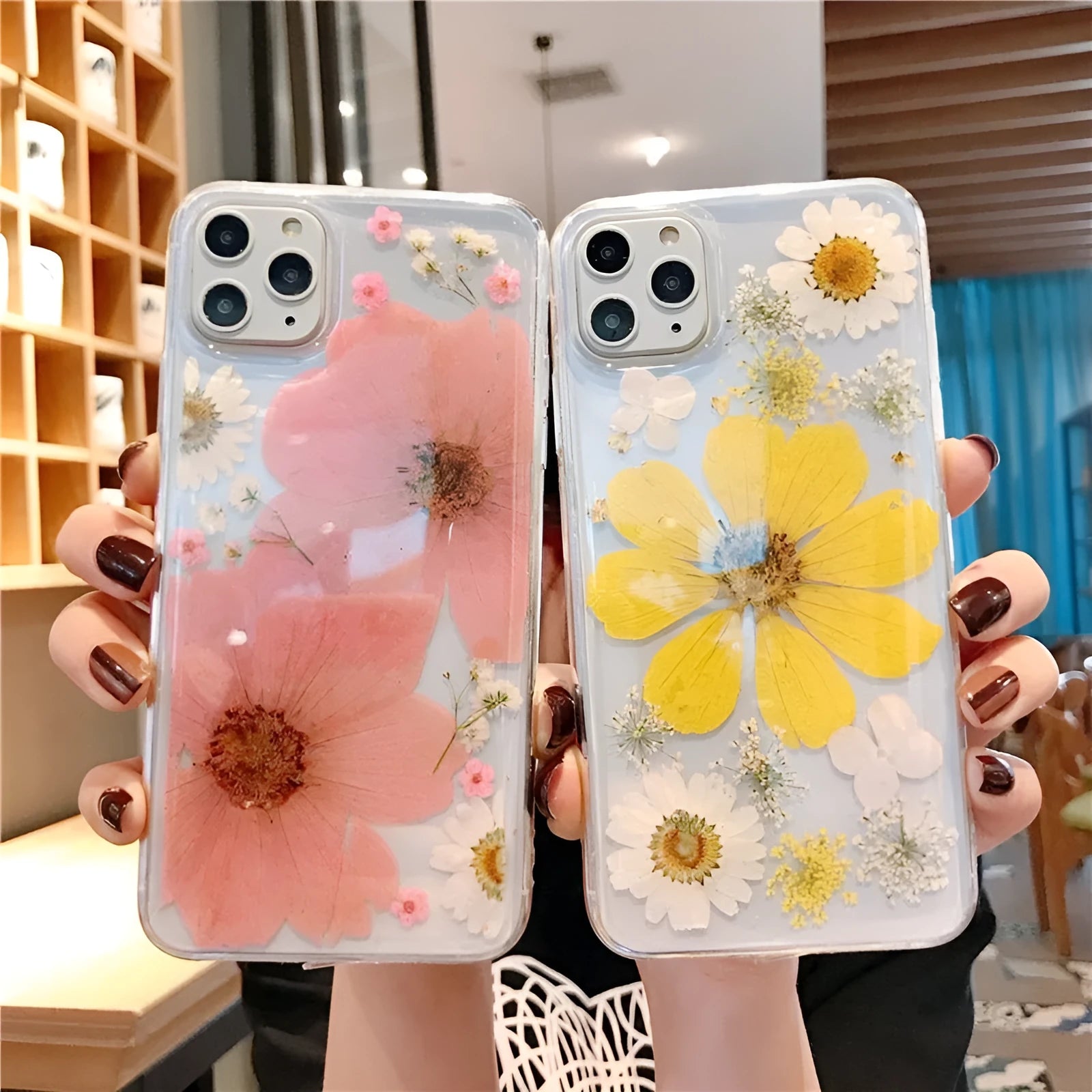Floral pattern iPhone case in pink or yellow colour on a mobile phone