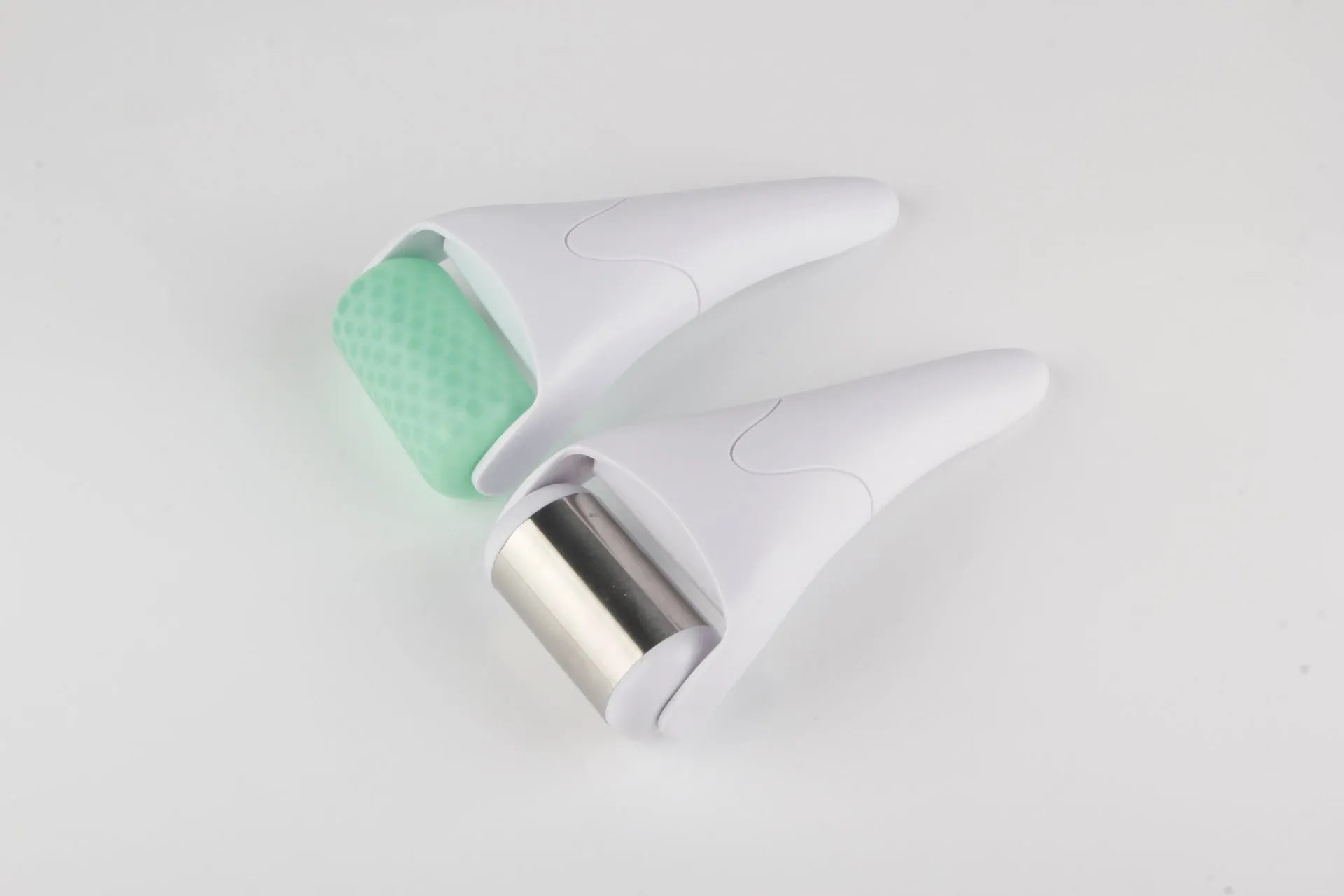 Plastic ice roller face roller in blue with removable head on white background