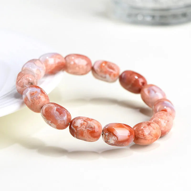 Natural cherry agate bracelet with barrel-shaped beads showing Ruyi geometric design