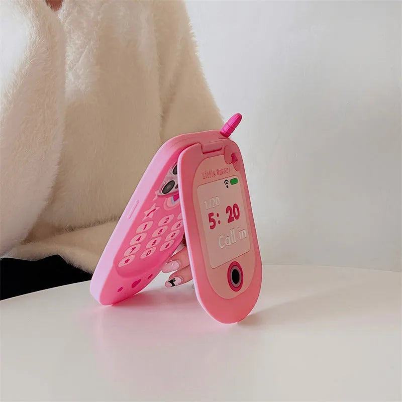 Pink silicone flip phone shaped iPhone case with built-in mirror for models 11 to 15