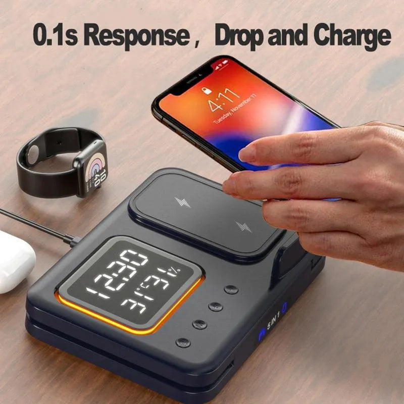 Black and white wireless charging dock station with digital clock display, charging a phone, watch, and headphones.