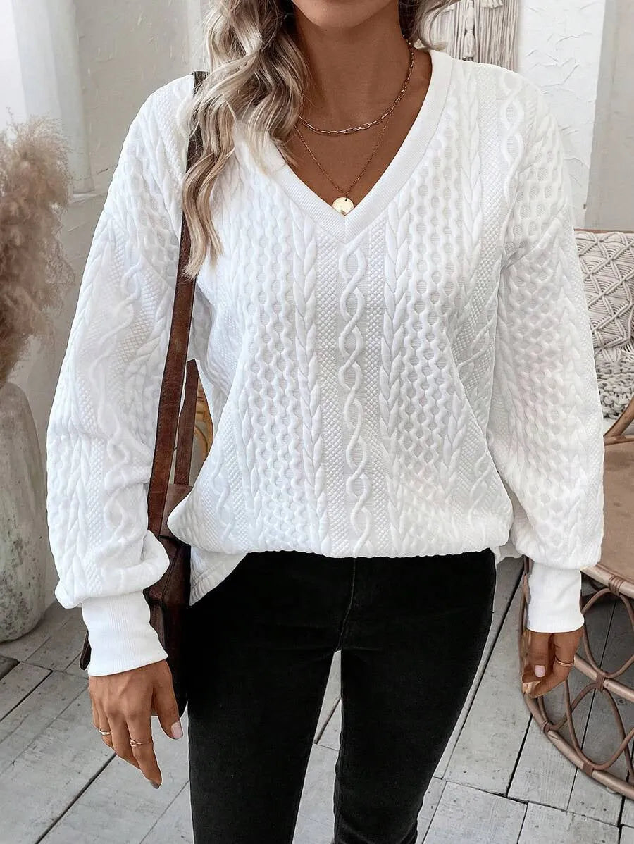 Milky white loose fit long sleeve t-shirt with a 3D pattern on a hanger