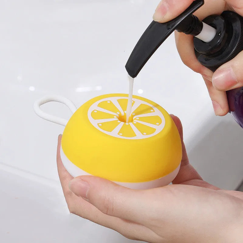 Soft yellow silicone pet bath brush with massage nodes and comb bristles for dog and cat washing.