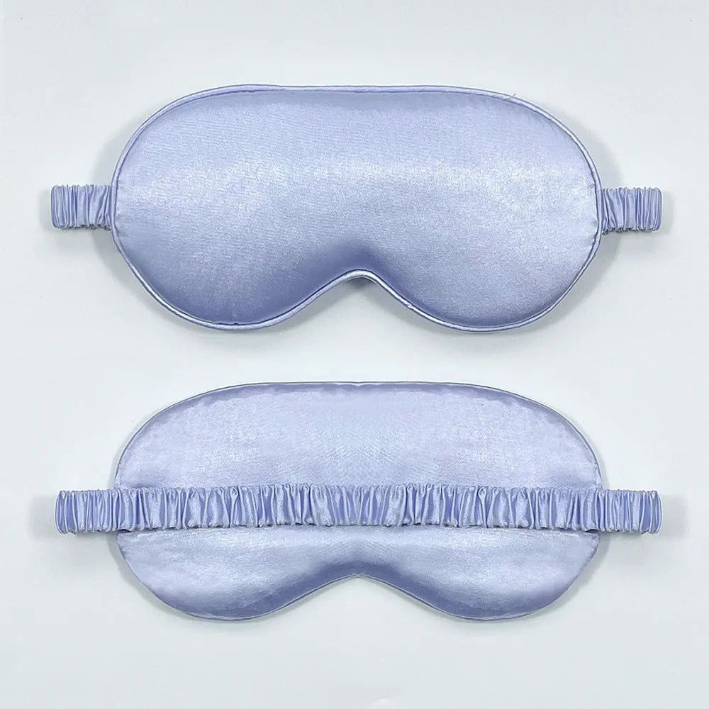 Reversible silk-like sleep eyeshade shown in multiple colour options including sky blue, wine red, and black.