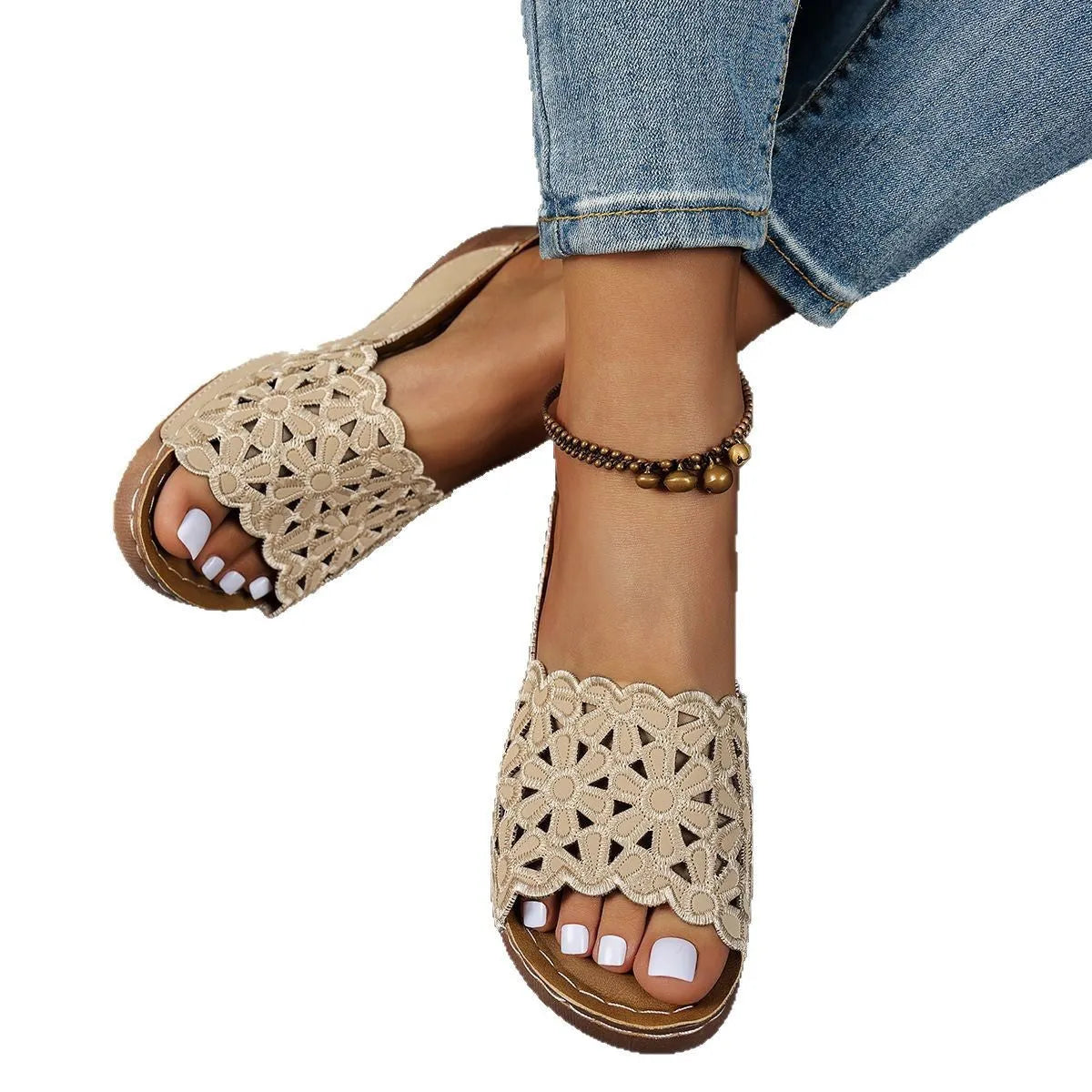 Women's black beach slipper with flower cutouts, a fish mouth toe, and a low wedge heel on a rubber sole.