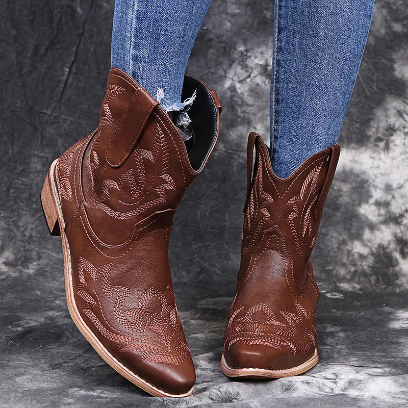 Women's blue embroidered Western cowgirl boots with a low wedge heel and pointed toe.