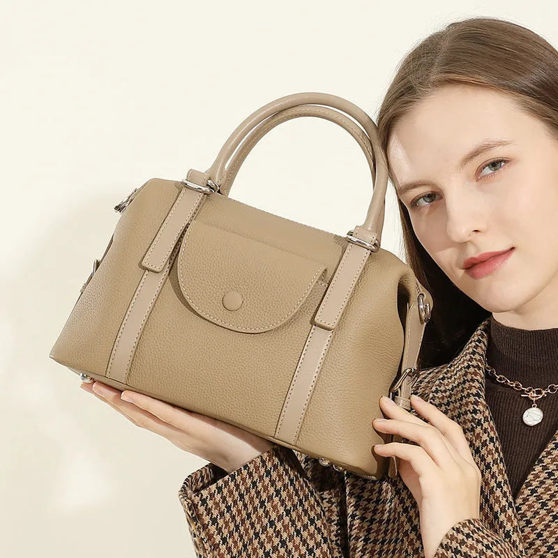 Genuine leather ladies handbag with contrast stitching and lock detail in street style