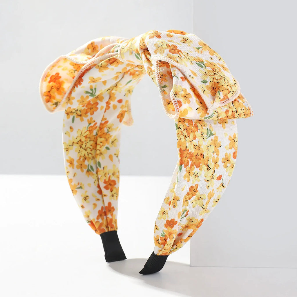 Handmade cloth hair bow with printed orchid and daisy flowers in pastoral style for women
