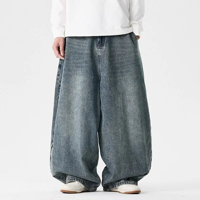 Men's plus-size baggy jeans in light blue denim with straight legs and low waist.