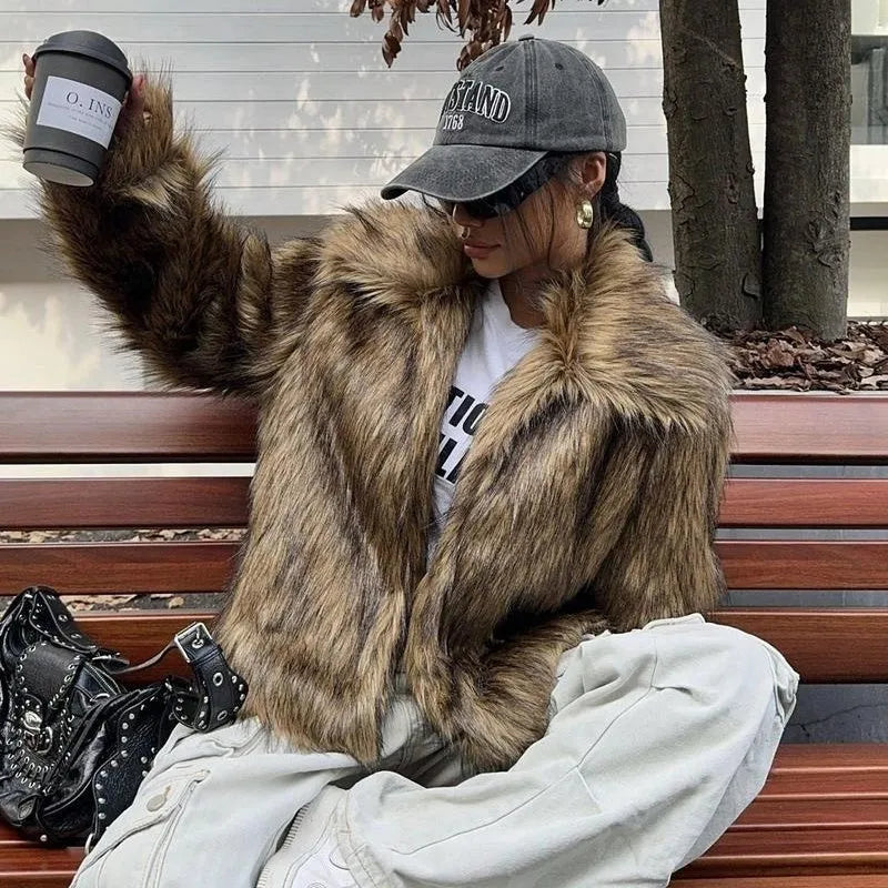 Women's short black artificial fur coat with a full fur collar and long sleeves.