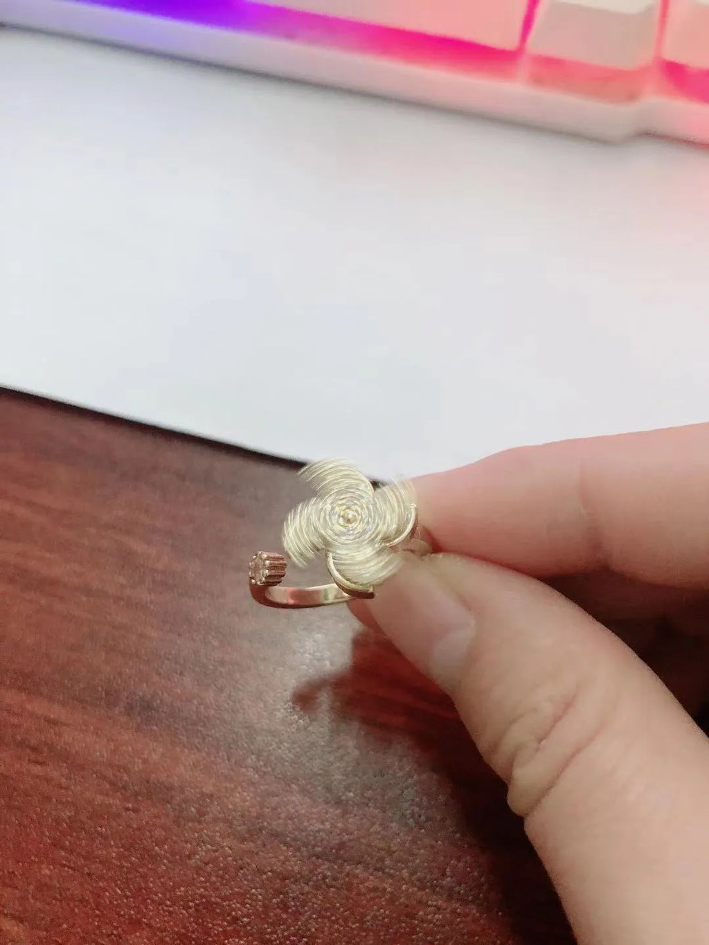Rotating geometric ring with micro-inlaid windmill design in gold or silver electroplated finish