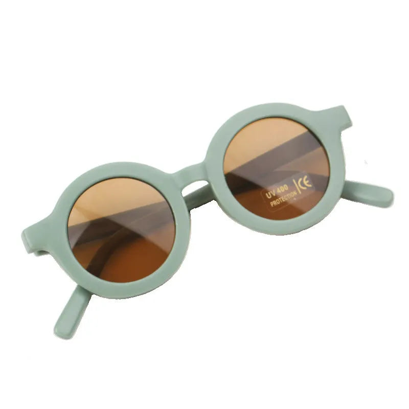 Children round frame retro mocha glasses on a child, showing the PC frame and resin lenses available in Beige, Brown, Green, Orange Red, Orange Yellow, Pink, and Purple colours