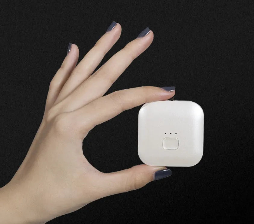 Mini USB air purifier necklace in pink showing compact wearable design with one-button control