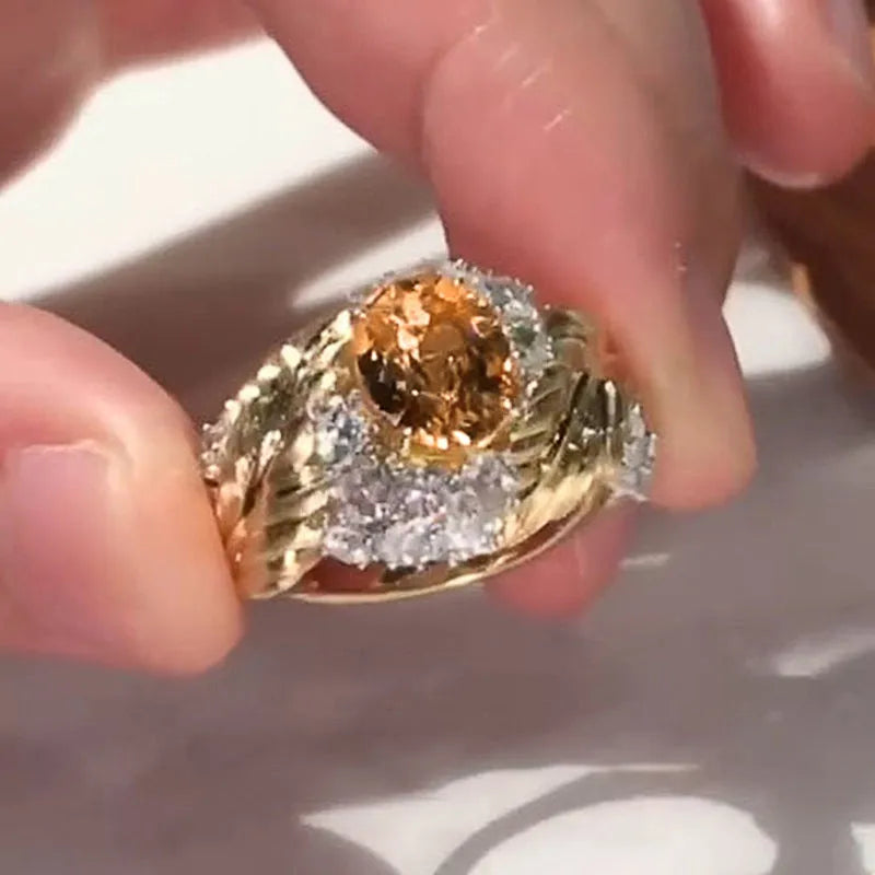 Gold coloured copper feather ring with embossed design and yellow zircon stone.