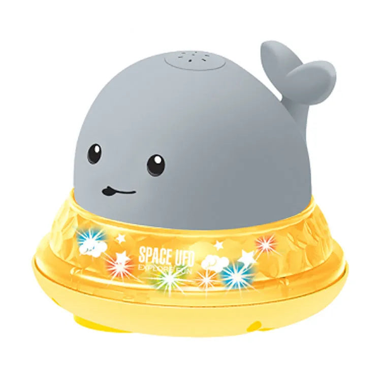 White and blue whale-shaped bath toy with water spray and LED lights floating in water