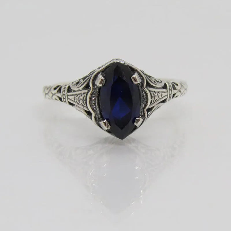 Women's silver geometric hollow ring showing alloy construction and detailed pattern