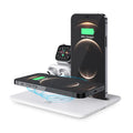 Black and white wireless desktop charging station for phone, headphones and watch on a desk