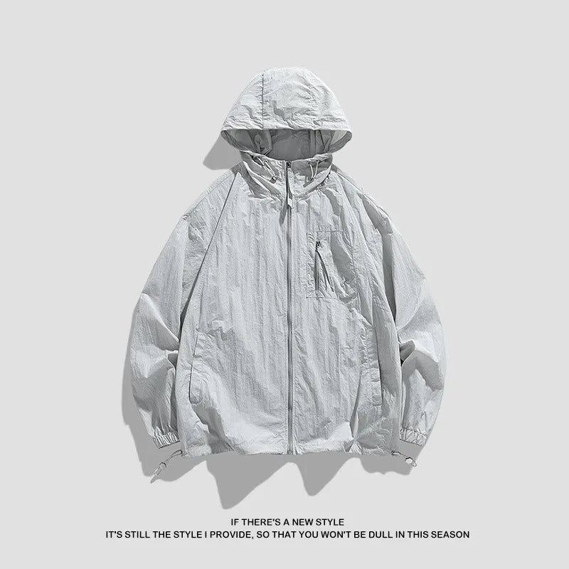 Lightweight Lycra hooded sun protection jacket in gray on a person standing outdoors