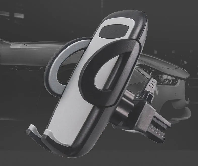 Black plastic mobile phone holder mounted on car air conditioning outlet with phone inserted