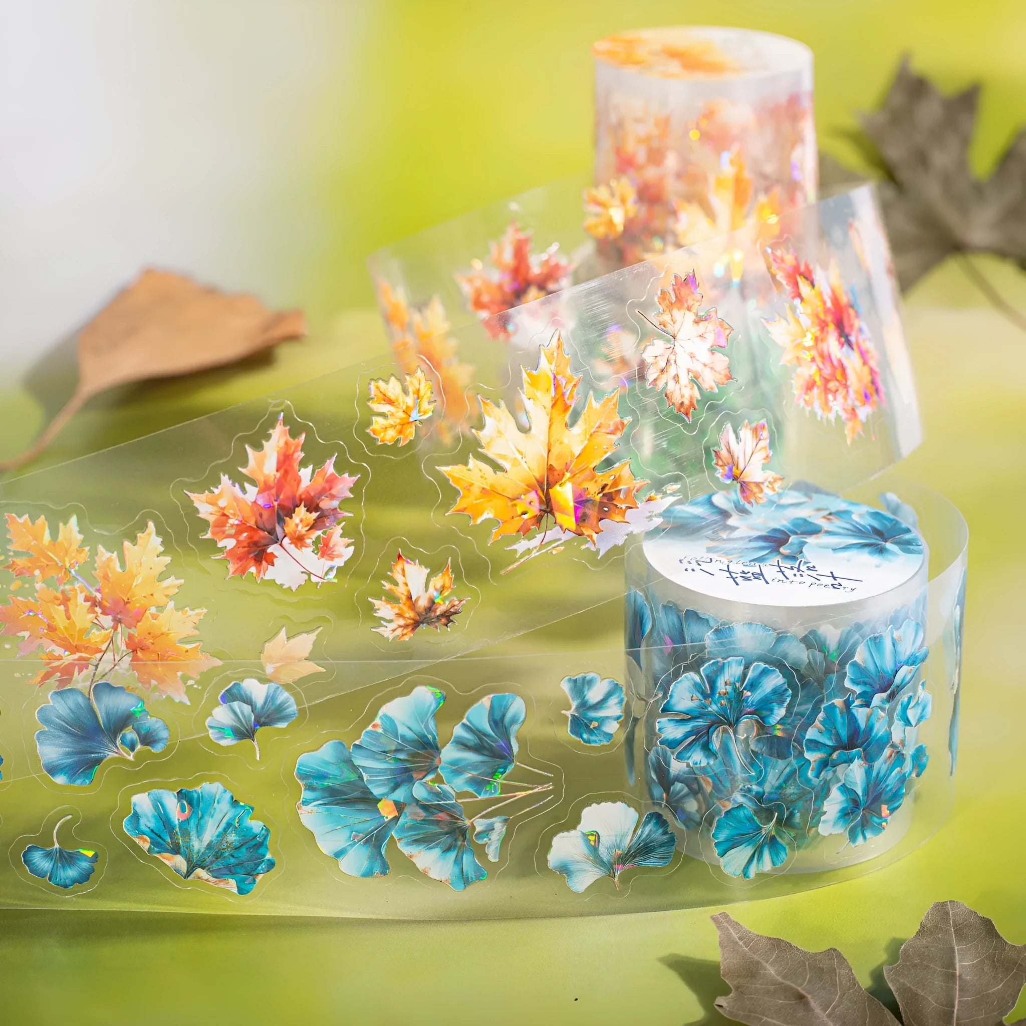 Six rolls of nature-themed decorative stickers showing gentle ginkgo, maple leaf, and blue fallen leaves designs.