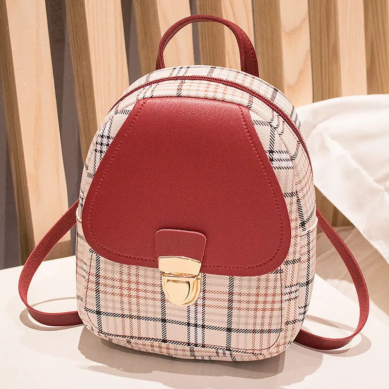 Diagonal shoulder phone bag in PU material showing adjustable strap and handheld carry option