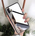 Black iPhone mirror phone case showing reflective glass back, compatible with multiple iPhone models.