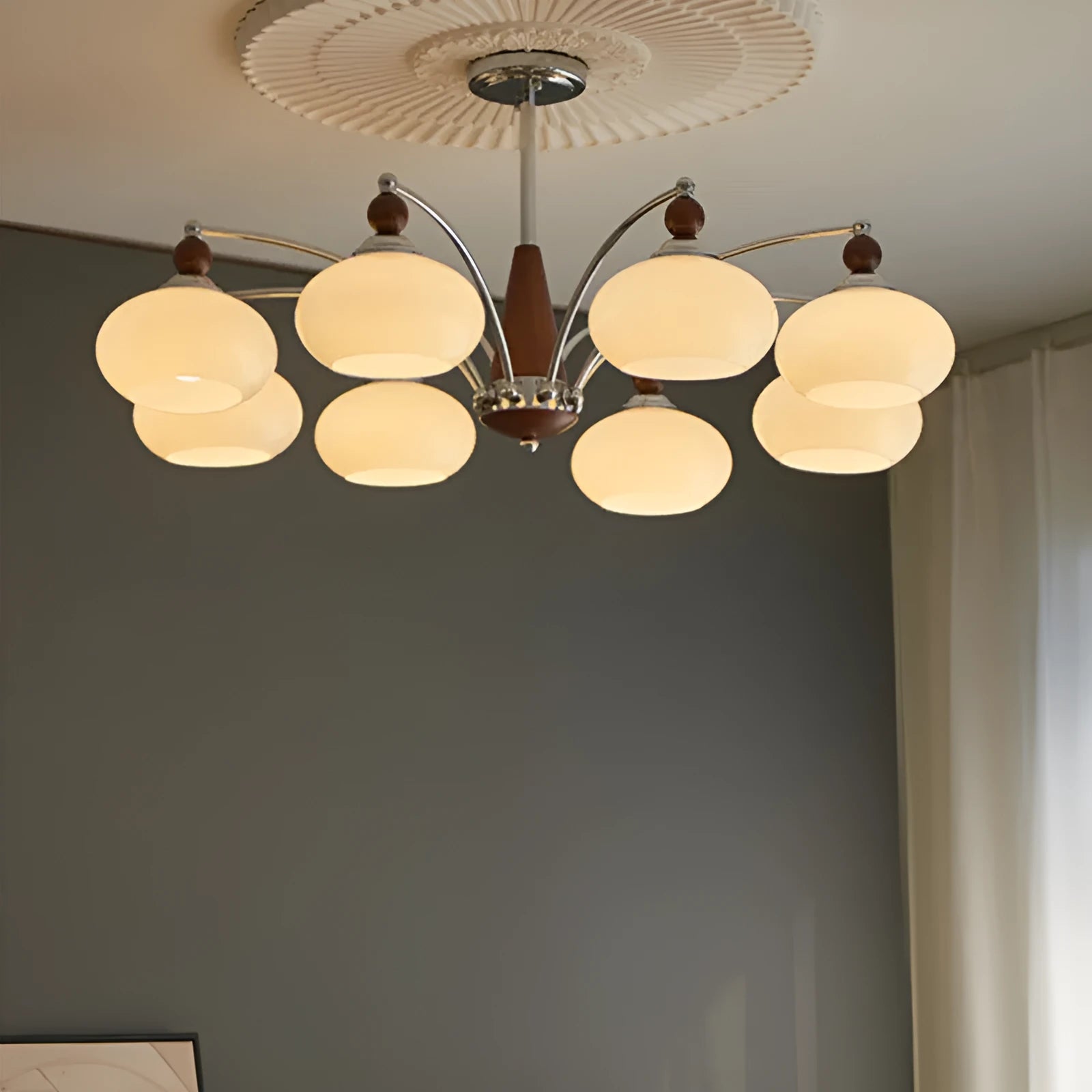 Persimmon glass and chrome chandelier with multiple lampshades in a Middle Ancient style