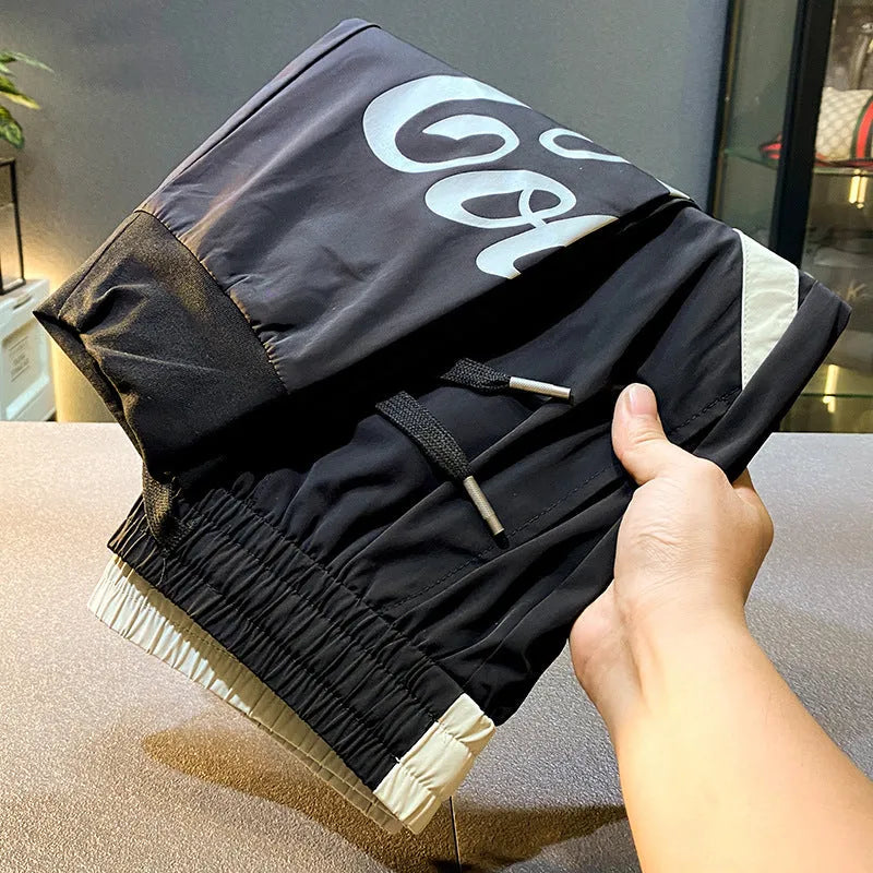Men's black cropped trousers with ankle banding in ultra-thin ice silk fabric laid flat to show casual design.