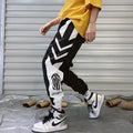 Men's hiphop trousers in black acetate fibre with tapered leg, side view