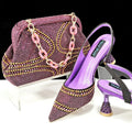 Women's pointed-toe high heel shoes with matching bag, featuring a stiletto heel and rhinestone detail on a synthetic leather upper.