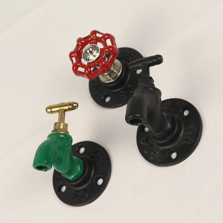 Metal wall-mounted towel rack hook designed like a water pipe, in a polished finish.