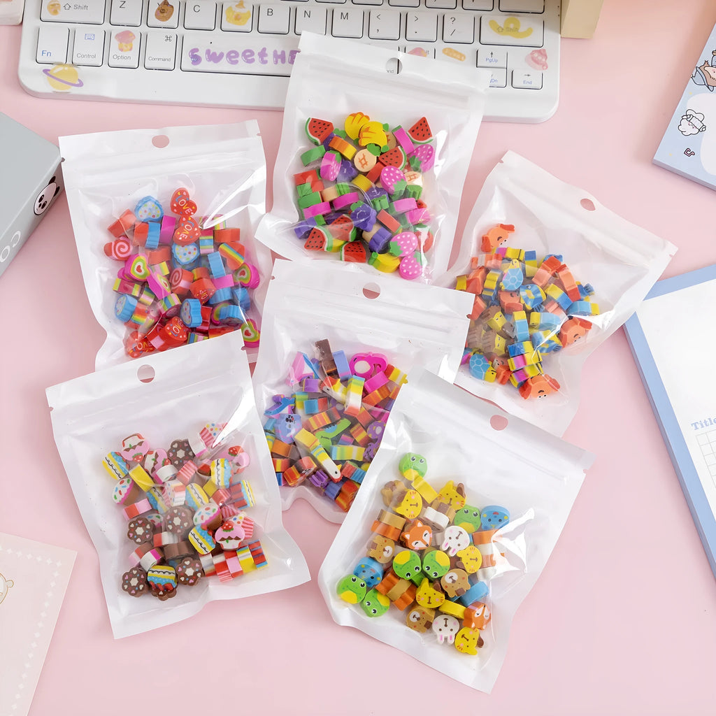 50 colourful cartoon mini erasers in shapes of fruits, animals, and cakes, displayed next to a pearlescent film bag.