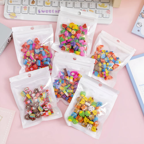 50 colourful cartoon mini erasers in shapes of fruits, animals, and cakes, displayed next to a pearlescent film bag.