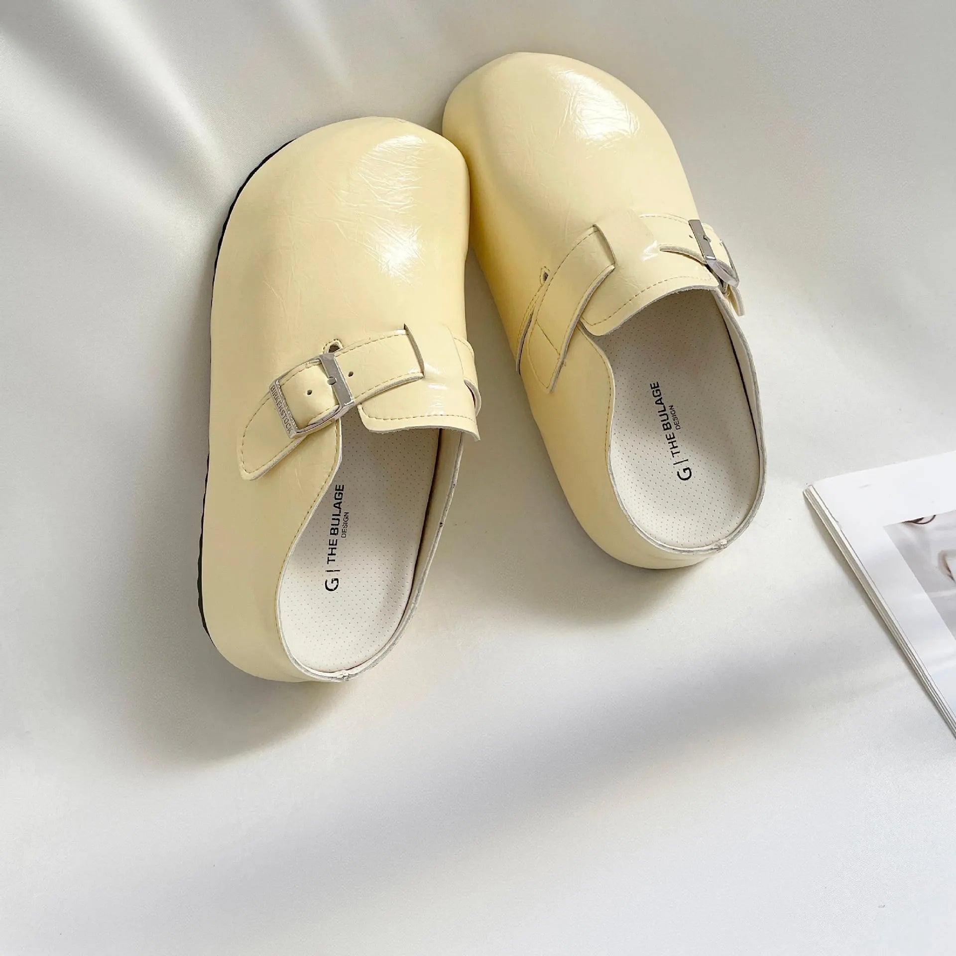 Flat buckle casual sneakers in yellow, black, silver, and creamy-white colours with rounded toe shape