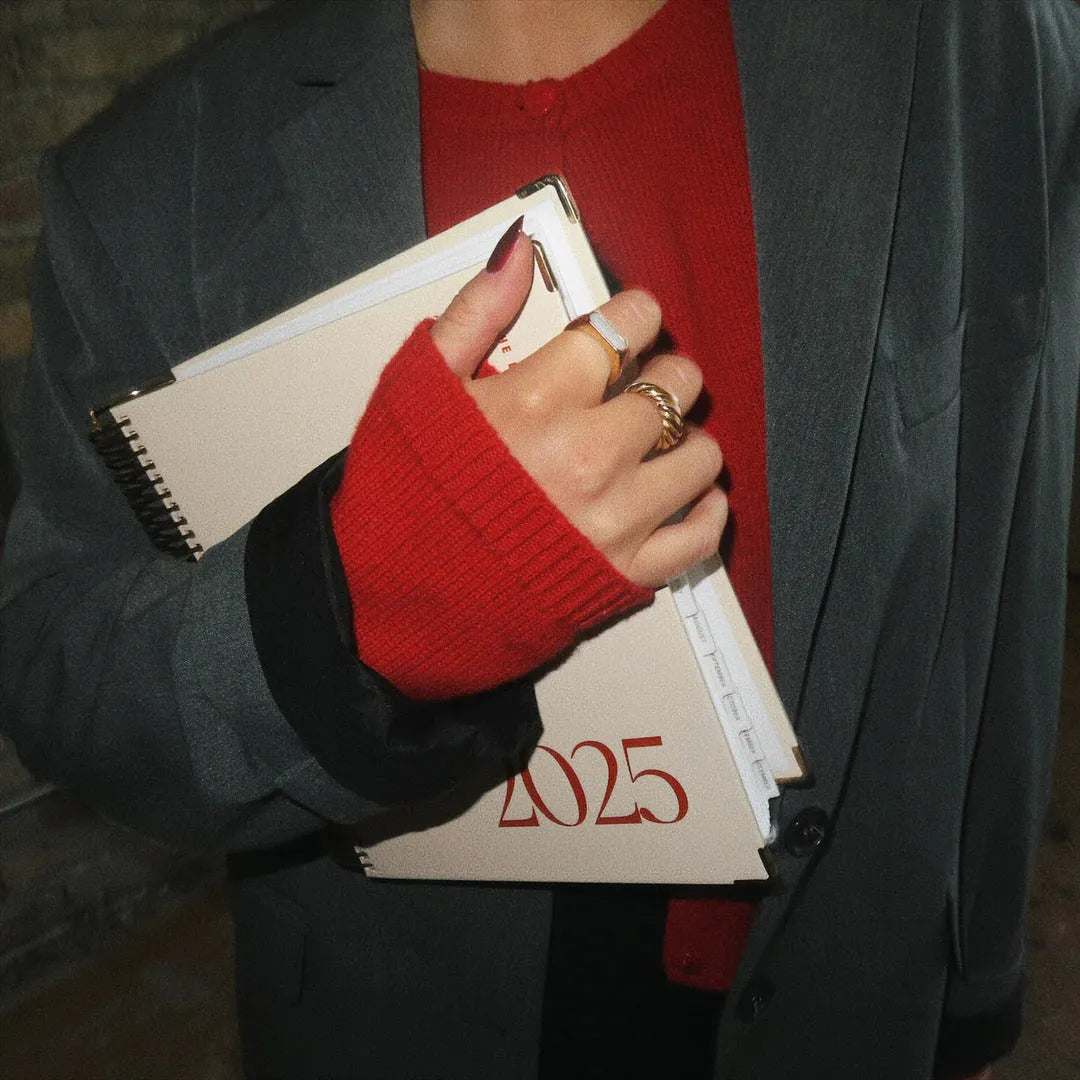 Cherry Red coil notebook with spiral binding open on a desk