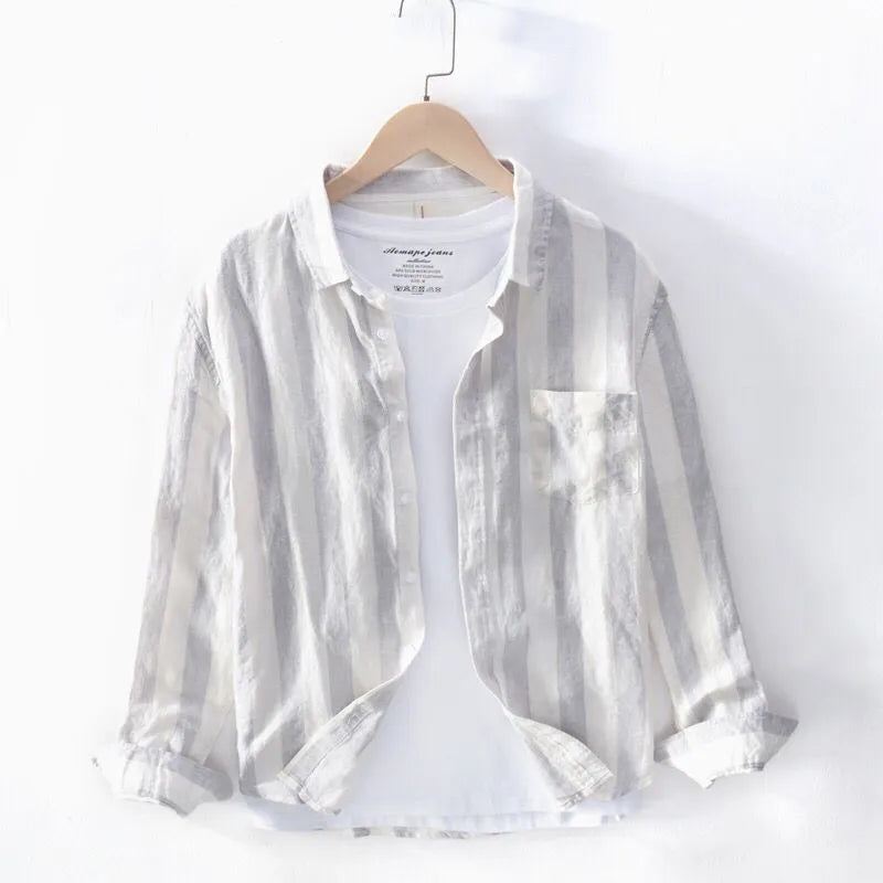 Men's loose fit blue long sleeve Hong Kong style shirt with fleece lining on a hanger.
