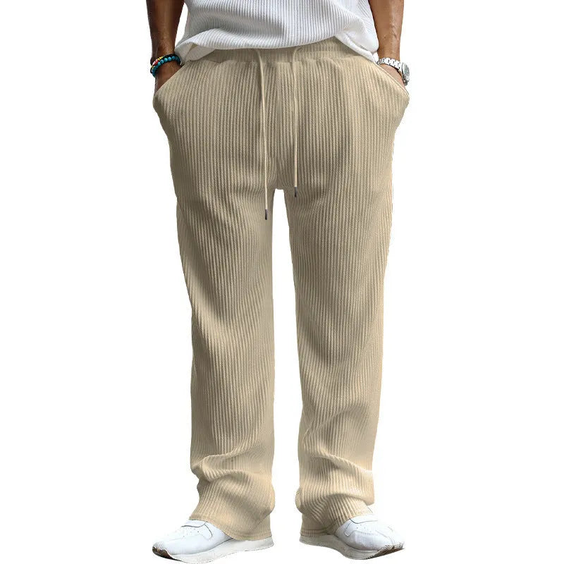 Man wearing army green striped high-waist straight-leg casual trousers.