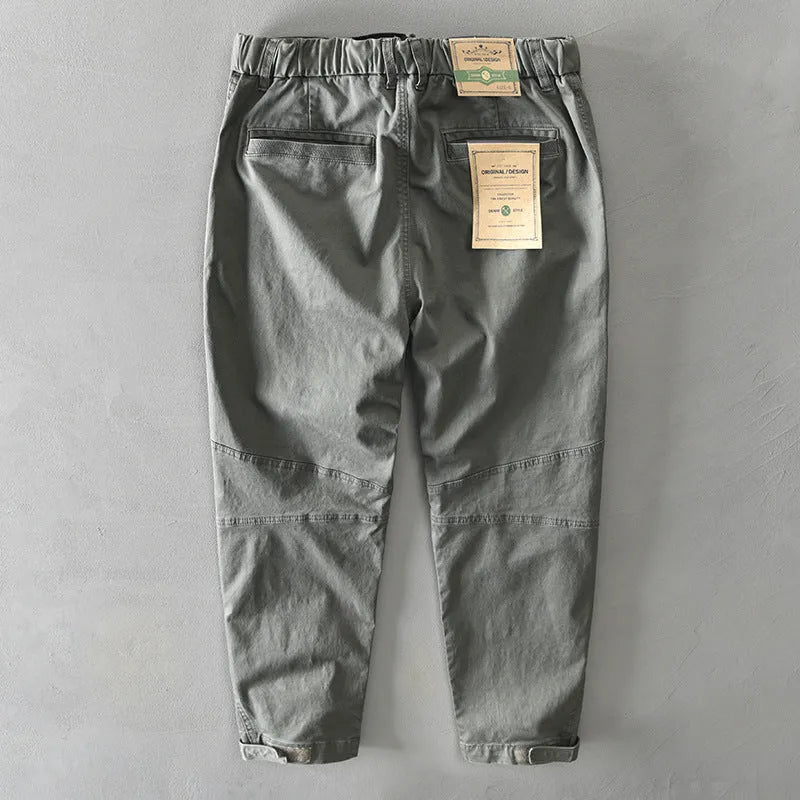 Men's loose-fit cotton overalls in army green colour, showing casual Japanese style and mid-waist design.