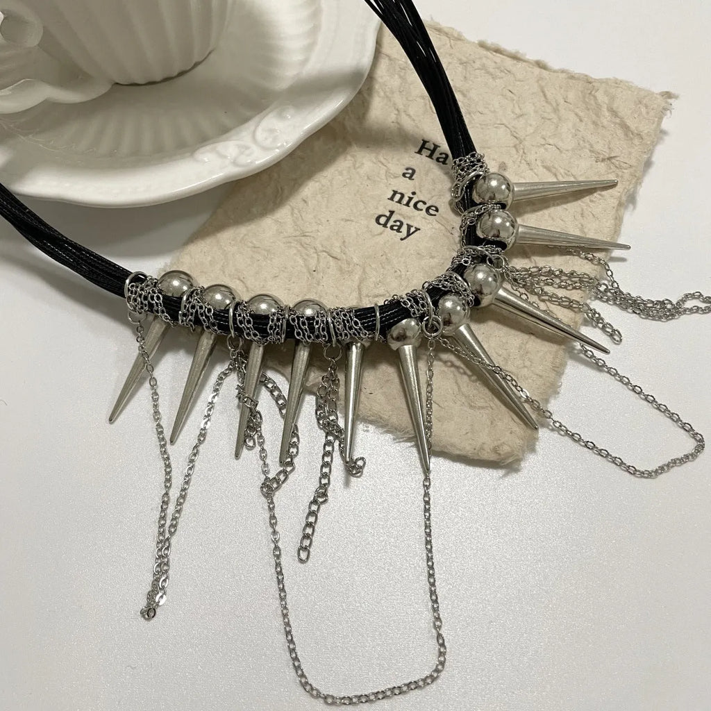 Leather necklace with winding tassel, round beads and point rivet details in electroplated picture colour