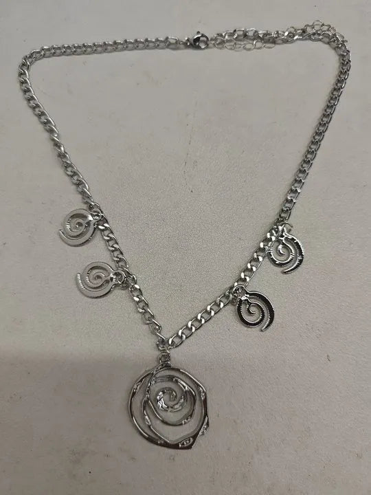 Spiral donut jewellery set showing gold tone necklace, bracelet and earrings with geometric circular design